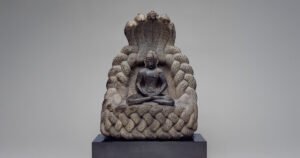 The Buddha under the protection of the Serpent King Muchalinda, sheltering him with a sacred hood during a storm. Image courtesy of the Art Institute of Chicago.